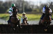 30 March 2024; So Des Flos, left, with Charlotte Butler up, Jumps the last on their way to winning the Fred Kenny Memorial Ladies National Handicap Steeplechase, from eventual second place Klarc Kent, right, with Jody Townend up, on day one of the Fairyhouse Easter Festival at Fairyhouse Racecourse in Ratoath, Meath. Photo by Seb Daly/Sportsfile