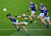 30 March 2024; Riordan O'Rourke of Leitrim kicks his side's first point under pressure from Ben Dempsey of Laois during the Allianz Football League Division 4 final match between Laois and Leitrim at Croke Park in Dublin. Photo by Ramsey Cardy/Sportsfile