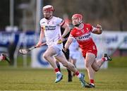30 March 2024; Fionn Devlin of Tyrone in action against John Mullan of Derry during the Allianz Hurling League Division 2B final match between Derry and Tyrone at the Derry GAA Centre of Excellence in Owenbeg, Derry. Photo by Ben McShane/Sportsfile