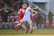 30 March 2024; Tiernan Morgan of Tyrone in action against John Mullan of Derry during the Allianz Hurling League Division 2B final match between Derry and Tyrone at the Derry GAA Centre of Excellence in Owenbeg, Derry. Photo by Ben McShane/Sportsfile