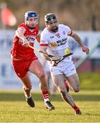 30 March 2024; Tiernan Morgan of Tyrone in action against Meehaul McGrath of Derry during the Allianz Hurling League Division 2B final match between Derry and Tyrone at the Derry GAA Centre of Excellence in Owenbeg, Derry. Photo by Ben McShane/Sportsfile