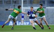30 March 2024; Eoin Buggie of Laois is tackled by Leitrim players, Ryan O'Rourke, left, and Mark Plunkett during the Allianz Football League Division 4 final match between Laois and Leitrim at Croke Park in Dublin. Photo by Shauna Clinton/Sportsfile