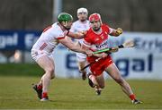 30 March 2024; John Mullan of Derry in action against Aidan Kelly of Tyrone during the Allianz Hurling League Division 2B final match between Derry and Tyrone at the Derry GAA Centre of Excellence in Owenbeg, Derry. Photo by Ben McShane/Sportsfile