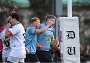 30 March 2024; Conor O'Tighearnach of UCD, right, celebrates with team-mate Matthew Healy after scoring their side's first try during the annual Men’s Rugby Colours match between Dublin University and UCD at College Park in Trinity College, Dublin. Photo by Sam Barnes/Sportsfile