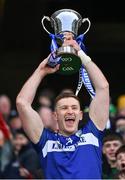 30 March 2024; Laois captain Evan O'Carroll lifts the trophy after winning the Allianz Football League Division 4 final match between Laois and Leitrim at Croke Park in Dublin. Photo by Ramsey Cardy/Sportsfile