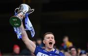 30 March 2024; Laois captain Evan O'Carroll lifts the trophy after winning the Allianz Football League Division 4 final match between Laois and Leitrim at Croke Park in Dublin. Photo by Ramsey Cardy/Sportsfile