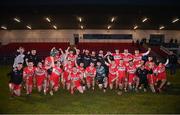 30 March 2024; Derry players and staff celebrate with the cup after the Allianz Hurling League Division 2B final match between Derry and Tyrone at the Derry GAA Centre of Excellence in Owenbeg, Derry. Photo by Ben McShane/Sportsfile