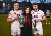30 March 2024; Dublin University captain Diarmuid McCormack, left, and Harry Colbert of Dublin University, right, are presented with the cups by Dublin University Football Club President Moira Flahive, centre, after the annual Men’s Rugby Colours match between Dublin University and UCD at College Park in Trinity College, Dublin. Photo by Sam Barnes/Sportsfile