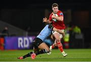 30 March 2024; Jack Crowley of Munster is tackled by Mason Grady of Cardiff during the United Rugby Championship match between Munster and Cardiff at Thomond Park in Limerick. Photo by Harry Murphy/Sportsfile