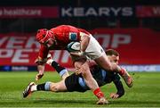 30 March 2024; John Hodnett of Munster evades the tackle of Cam Winnett of Cardiff during the United Rugby Championship match between Munster and Cardiff at Thomond Park in Limerick. Photo by Harry Murphy/Sportsfile