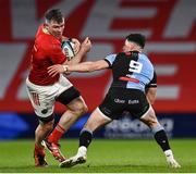 30 March 2024; Peter O'Mahony of Munster evades the tackle of Ellis Bevan of Cardiff during the United Rugby Championship match between Munster and Cardiff at Thomond Park in Limerick. Photo by Harry Murphy/Sportsfile
