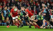 30 March 2024; Peter O’Mahony of Munster offloads to teammate Antoine Frisch during the United Rugby Championship match between Munster and Cardiff at Thomond Park in Limerick. Photo by Brendan Moran/Sportsfile