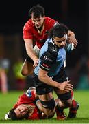 30 March 2024; Mackenzie Martin of Cardiff is tackled by Antoine Frisch and Joey Carbery of Munster during the United Rugby Championship match between Munster and Cardiff at Thomond Park in Limerick. Photo by Harry Murphy/Sportsfile