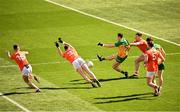 31 March 2024; Kevin McGettigan of Donegal shoots at goal under pressure from Armagh players Oisín Conaty, 15, and Aaron McKay, 3, during the Allianz Football League Division 2 Final match between Armagh and Donegal at Croke Park in Dublin. Photo by Ramsey Cardy/Sportsfile