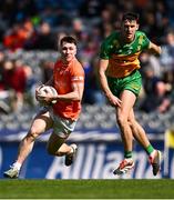 31 March 2024; Oisín Conaty of Armagh in action against Michael Langan of Donegal during the Allianz Football League Division 2 Final match between Armagh and Donegal at Croke Park in Dublin. Photo by Piaras Ó Mídheach/Sportsfile