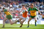 31 March 2024; Jarly Óg Burns of Armagh in action against Ciarán Moore of Donegal during the Allianz Football League Division 2 Final match between Armagh and Donegal at Croke Park in Dublin. Photo by John Sheridan/Sportsfile