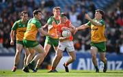 31 March 2024; Peter McGrane of Armagh in action against Donegal players, from left, Jamie Brennan, Hugh McFadden and Shane O'Donnell during the Allianz Football League Division 2 Final match between Armagh and Donegal at Croke Park in Dublin. Photo by Ramsey Cardy/Sportsfile