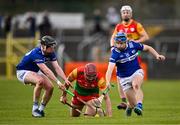 31 March 2024; Jack McCullagh of Carlow is tackled by John Lennon, left, and Tomas Keyes of Laois during the Allianz Hurling League Division 2A Final match between Carlow and Laois at Netwatch Cullen Park in Carlow. Photo by Ben McShane/Sportsfile