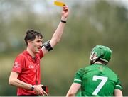 31 March 2024; Referee Conor Daly shows a yellow card to Daniel Teague of Fermanagh during the Allianz Hurling League Division 3B Final match between Fermanagh and Warwickshire at St Joseph's Park in Ederney, Fermanagh. Photo by Sam Barnes/Sportsfile