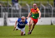 31 March 2024; Jer Quinlan of Laois gets the sliotar away despite the attention of Jack McCullagh of Carlow during the Allianz Hurling League Division 2A Final match between Carlow and Laois at Netwatch Cullen Park in Carlow. Photo by Ben McShane/Sportsfile