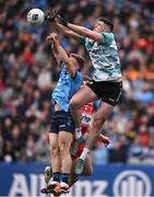31 March 2024; Derry goalkeeper Odhran Lynch fists clear under pressure from Cian Murphy of Dublin during the Allianz Football League Division 1 Final match between Dublin and Derry at Croke Park in Dublin. Photo by Ramsey Cardy/Sportsfile