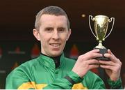 31 March 2024; Jockey Mark Walsh with the Gold Cup after riding Spillane's Tower to victory in the WillowWarm Gold Cup on day two of the Fairyhouse Easter Festival at Fairyhouse Racecourse in Ratoath, Meath. Photo by Seb Daly/Sportsfile