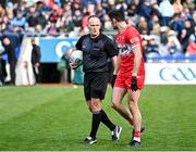 31 March 2024; Referee Conor Lane with Christopher McKaigue of Derry after the end of normal time in the Allianz Football League Division 1 Final match between Dublin and Derry at Croke Park in Dublin. Photo by Piaras Ó Mídheach/Sportsfile