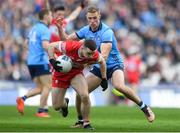 31 March 2024; Niall Toner of Derry is tackled by Paul Mannion of Dublin during the Allianz Football League Division 1 Final match between Dublin and Derry at Croke Park in Dublin. Photo by John Sheridan/Sportsfile