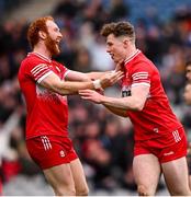 31 March 2024; Eoin McEvoy of Derry celebrates with Conor Glass, left, after scoring their side's third goal during the Allianz Football League Division 1 Final match between Dublin and Derry at Croke Park in Dublin. Photo by Ramsey Cardy/Sportsfile