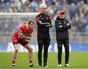 31 March 2024; Brendan Rogers, left, selector Murtagh O'Brien and Derry manager Mickey Harte look on during the penalty shoot-out in the  Allianz Football League Division 1 Final match between Dublin and Derry at Croke Park in Dublin. Photo by John Sheridan/Sportsfile