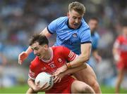 31 March 2024; Paul Cassidy of Derry is tackled by Seán Bugler of Dublin during the Allianz Football League Division 1 Final match between Dublin and Derry at Croke Park in Dublin. Photo by John Sheridan/Sportsfile