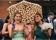 1 April 2024; Racegoers shelter from the rain as they arrive for racing on day three of the Fairyhouse Easter Festival at Fairyhouse Racecourse in Ratoath, Meath. Photo by Seb Daly/Sportsfile