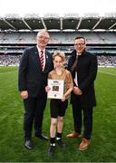 31 March 2024; Cruz Atkinson and Cillian Hanrahan, referees of the Cumann na mBunscol halftime games, were honoured on behalf of their whole team for their joint contributions this year and were recognised by  at half time of Sunday’s Allianz Football League Division 1 Final between Dublin and Derry. Pictured is Cillian Hanrahan, with Uachtarán Chumann Lúthchleas Gael Jarlath Burns and Mark Brennan, Head of Market Management at Allianz Insurance. Photo by Ramsey Cardy/Sportsfile