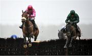 1 April 2024; Brewin'upastorm, left, with Jack Kennedy up, jump the last on their way to winning the Rathbarry and Glenview Studs Hurdle, from eventual second place Zarak The Brave, right, with Paul Townend up, on day three of the Fairyhouse Easter Festival at Fairyhouse Racecourse in Ratoath, Meath. Photo by Seb Daly/Sportsfile