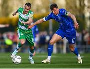 1 April 2024; Graham Burke of Shamrock Rovers in action against Kacper Radkowski of Waterford during the SSE Airtricity Men's Premier Division match between Waterford and Shamrock Rovers at the Regional Sports Centre in Waterford. Photo by Tyler Miller/Sportsfile