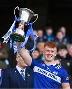 30 March 2024; James Kelly of Laois lifts the trophy after the Allianz Football League Division 4 final match between Laois and Leitrim at Croke Park in Dublin. Photo by Ramsey Cardy/Sportsfile