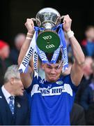 30 March 2024; Kevin Swayne of Laois lifts the trophy after the Allianz Football League Division 4 final match between Laois and Leitrim at Croke Park in Dublin. Photo by Ramsey Cardy/Sportsfile