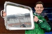 1 April 2024; Jockey JJ Slevin celebrates with the trophy after riding Intense Raffles to victory in BoyleSports Irish Grand National Steeplechase on day three of the Fairyhouse Easter Festival at Fairyhouse Racecourse in Ratoath, Meath. Photo by Seb Daly/Sportsfile