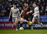 5 April 2024; James Clarke of Bohemians in action against Harvey Macadam, left, and Ben McCormack of Waterford during the SSE Airtricity Men's Premier Division match between Bohemians and Waterford at Dalymount Park in Dublin. Photo by Piaras Ó Mídheach/Sportsfile