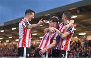 5 April 2024; Adam O'Reilly of Derry City celebrates with teammates Ciarán Coll, left, and Michael Duffy after scoring their side's first goal during the SSE Airtricity Men's Premier Division match between Derry City and Dundalk at The Ryan McBride Brandywell Stadium in Derry. Photo by Ramsey Cardy/Sportsfile
