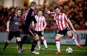 5 April 2024; Will Patching of Derry City in action against Daryl Horgan, left, and John Mountney of Dundalk during the SSE Airtricity Men's Premier Division match between Derry City and Dundalk at The Ryan McBride Brandywell Stadium in Derry. Photo by Ramsey Cardy/Sportsfile
