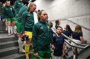 5 April 2024; Republic of Ireland captain Katie McCabe and her player escort before the UEFA Women's European Championship qualifying group A match between France and Republic of Ireland at Stade Saint-Symphorien in Metz, France. Photo by Stephen McCarthy/Sportsfile