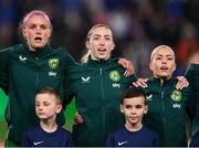 5 April 2024; Republic of Ireland players, from left, Caitlin Hayes, Megan Connolly and Denise O'Sullivan stand for the playing of the National Anthem before the UEFA Women's European Championship qualifying group A match between France and Republic of Ireland at Stade Saint-Symphorien in Metz, France. Photo by Stephen McCarthy/Sportsfile