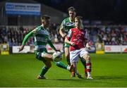 5 April 2024; Brandon Kavanagh of St Patrick's Athletic in action against Darragh Burns of Shamrock Rovers, left, during the SSE Airtricity Men's Premier Division match between St Patrick's Athletic and Shamrock Rovers at Richmond Park in Dublin. Photo by Seb Daly/Sportsfile