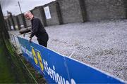 6 April 2024; Branding co-ordinator Donal Quynn applies the finishing touches to the Lidl branding before the Lidl LGFA National League Division 3 final match between Clare and Roscommon at St Brendan’s Park in Birr, Offaly. Photo by Ben McShane/Sportsfile