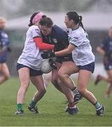 6 April 2024; Cliodhna Ni She of Carlow is tackled by Karen O'Leary, left, and Ellie Woulfe of Limerick during the Lidl LGFA National League Division 4 final match between Carlow and Limerick at St Brendan’s Park in Birr, Offaly. Photo by Ben McShane/Sportsfile