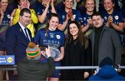 6 April 2024; Cliodhna Ni She of Carlow is presented with the Player of the Match award by, from left, Uachtarán Cumann Peil Gael na mBan, Mícheál Naughton, Christine McIntyre, Senior Partnerships & Events Manager, Lidl Ireland and Northern Ireland, and Jamie O’Rourke, Partnerships & Events Manager, Lidl Ireland and Northern Ireland, after the Lidl LGFA National League Division 4 final match between Carlow and Limerick at St Brendan’s Park in Birr, Offaly. Photo by Ben McShane/Sportsfile