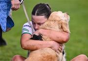 6 April 2024; Ellie Woulfe of Limerick is consoled by her dog Lexi after her side's defeat in the Lidl LGFA National League Division 4 final match between Carlow and Limerick at St Brendan’s Park in Birr, Offaly. Photo by Ben McShane/Sportsfile