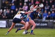 6 April 2024; Caoimhe Cregg of Roscommon in action against Louise Griffin, left, and Laurie Ryan of Clare during the Lidl LGFA National League Division 3 final match between Clare and Roscommon at St Brendan’s Park in Birr, Offaly. Photo by Ben McShane/Sportsfile
