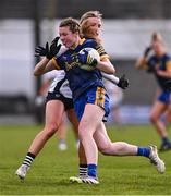 6 April 2024; Lisa O'Rourke of Roscommon is tackled by Teresa Collins of Clare during the Lidl LGFA National League Division 3 final match between Clare and Roscommon at St Brendan’s Park in Birr, Offaly. Photo by Ben McShane/Sportsfile